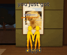 two yellow figures holding hands in front of a framed picture that says you just got capyd