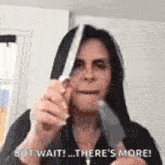 a woman is holding a knife in her mouth and says `` but wait ! there 's more ! ''