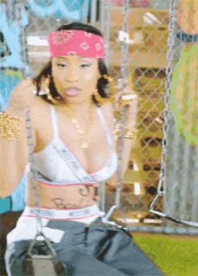 a woman is wearing a pink bandana and a bra that says victoria 's secret