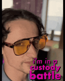 a man wearing sunglasses with the words " i 'm in a custody battle " on the bottom