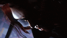 a person is standing in a dark room with smoke coming out of their mouth