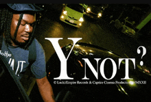 a man with dreadlocks is standing in front of a car with the words y not written on it