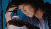 a person looking at something with a light on it