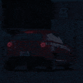 a car is driving down a street at night