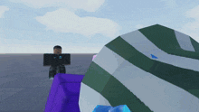 a man in a black nike shirt stands next to a purple block