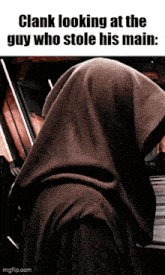 a man with a hood on his head is looking at another man who stole his main .