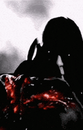 a silhouette of a person with blood coming out of their chest