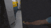 a group of minions are standing in a hallway .