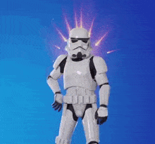 a storm trooper from star wars is holding a red pillow with a crown on it .