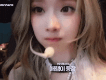 a close up of a woman 's face with a microphone on her mouth .