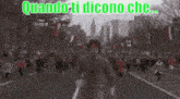 a man is running down a street with the words quando ti dicono che