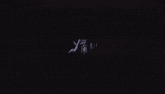 a girl with long black hair is standing in a dark room with a sword in her hand
