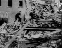 a black and white photo of a destroyed building that says pathe