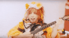 a person playing a guitar with a mask on their face