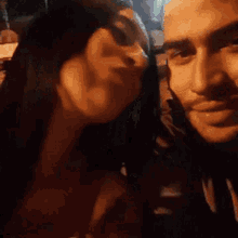 a man and woman are kissing in the dark