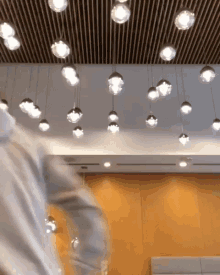 a blurry picture of a room with a lot of lights hanging from the ceiling