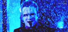 a close up of a man 's face in a blue light