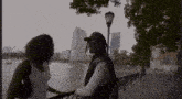 a man and a woman are standing next to each other on a sidewalk