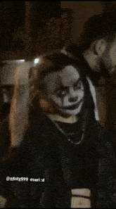 a woman is wearing a clown costume and has a ponytail .