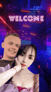 a man and a woman are standing next to each other with the words welcome behind them
