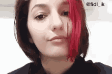 a woman with red hair is making a funny face