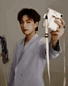 a man in a blue jacket is holding a camera