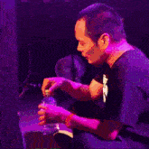 a man wearing a black shirt with the letter f on the front