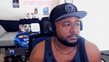 a man wearing headphones and a hat with a skull and crossbones logo on it