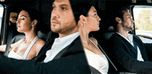 a man and a woman are sitting in the back of a car