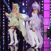a woman in a fairy costume is standing next to another woman