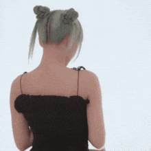a woman with green hair is wearing a black dress