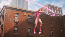 a woman in a pink superhero costume is flying over a brick building