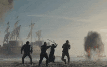 a group of men standing on a beach with swords