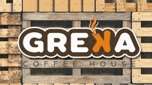a logo for grexa coffee house is on a wooden pallet