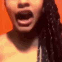 a close up of a woman 's face with her mouth wide open .
