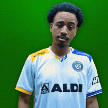 a man wearing a white shirt with aldi on it