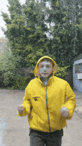 a man wearing a yellow jacket with a prada logo on the front
