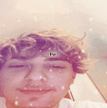 a close up of a man 's face with the word hi on his forehead