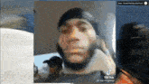 a man with a beard is talking on a cell phone .
