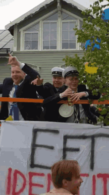 a group of people holding a sign that says eef