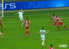 a soccer game is being played in front of an advertisement for ps5