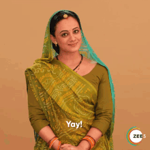 a woman in a green saree says yay in front of a zee5 logo