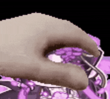 a close up of a person 's hand holding a purple object in front of a purple background .