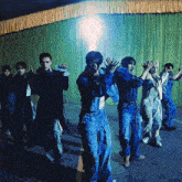 a group of young men are dancing on a stage