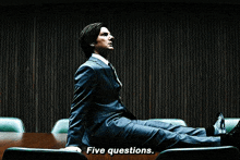 a close up of a man 's face with the words five questions visible
