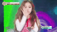 a girl with long hair is blowing a kiss in front of a colorful background