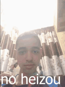 a young man taking a picture of himself with the words no heizou on the bottom