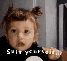 a little girl is making a funny face and saying suit yourself