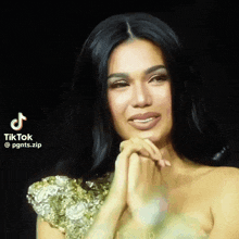 a woman in a gold dress has a tiktok watermark on her face