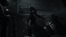 a black and white photo of a woman holding a knife .